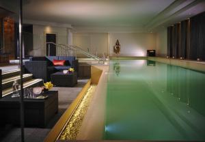 a swimming pool in a room with a couch and a living room at Westport Coast Hotel in Westport