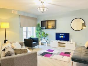 a living room with a couch and a tv at Luxury Flat at Temple Bar Dublin in Dublin