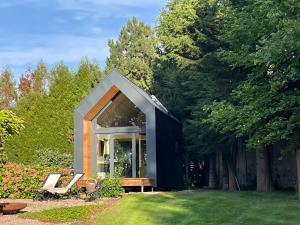 a small black and white house in a yard at LA MAISON D INÈS and UGOLIN & SPA in Baccarat