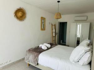 a bedroom with a bed with two towels on it at L'arbre qui chante in Saint-Étienne-de-Sermantin +113 photos