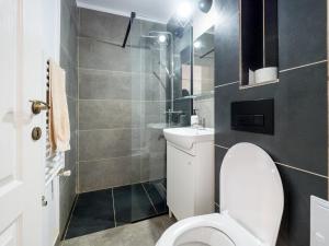 a small bathroom with a toilet and a shower at MDC Apartments in Timişoara