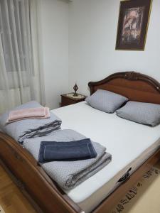 a bedroom with a bed with towels on it at Luxury Apartment in Mladenovac