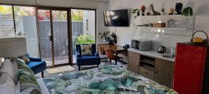 a living room with a couch and a table and a kitchen at Private Suite Nautilus Beach Front Resort in Coffs Harbour