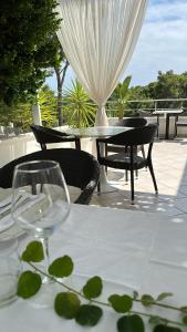 a table with two wine glasses on a patio at Petra Maris B&B in Peschici