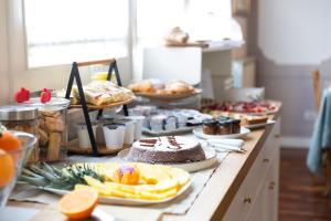 a buffet with cakes and other foods on a table at B&B Palazzo Mirelli in Naples