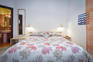 a bedroom with a bed with a floral bedspread at B&B Galatea in Maiori
