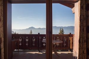 a view of the mountains from the balcony of a house at les 7 laux immobilier chalet A in Prapoutel
