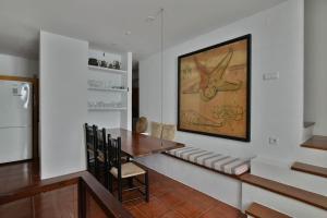 a dining room with a table and a refrigerator at Casa Manolo in Cadaqués