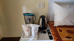 a blender sitting on a counter next to a bed at Host Labs Homestay - Premium View - Close to Kaichi Dham, Bhimtal, Sattal, and more in Bhīm Tāl