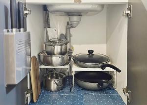 a kitchen with pots and pans on a shelf at Brick stay in Seoul