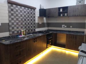 a kitchen with a sink and a counter with lights at The Breeze Apartment in Ikeja