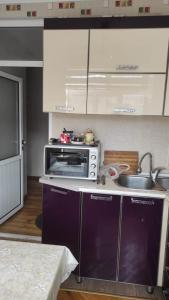 a small kitchen with a sink and a microwave at AYXAN HOSTEL in Ganja