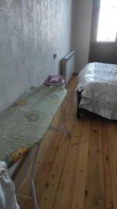 a room with a bed and a rug on the floor at AYXAN HOSTEL in Ganja