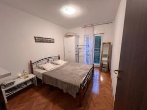 a bedroom with a bed in a room at Apartments "Helios" in Njivice