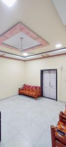 a large room with a bed and a garage door at Hotel Seaview in Murud
