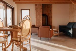 a living room with a table and chairs and a couch at Chaty Jagi in Czorsztyn