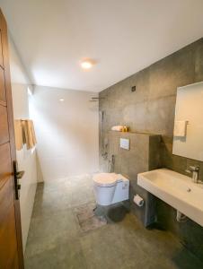 a bathroom with a toilet and a sink at HIDEOUT BY CMB APARTMENTS in Mount Lavinia