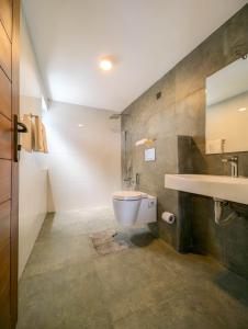 a bathroom with a toilet and a sink at HIDEOUT BY CMB APARTMENTS in Mount Lavinia