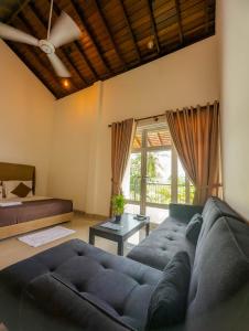 een woonkamer met een bank en een bed bij HIDEOUT BY CMB APARTMENTS in Mount Lavinia