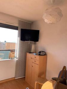 a living room with a flat screen tv on the wall at 4 personnes in Chamrousse