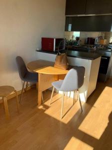 a kitchen with a table and two chairs and a table at 4 personnes in Chamrousse