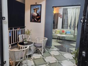 a living room with chairs and a table and a couch at Hebron Haven in Jaigaon