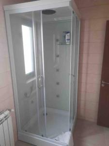 a shower with a glass door in a bathroom at La VILA in Bacău