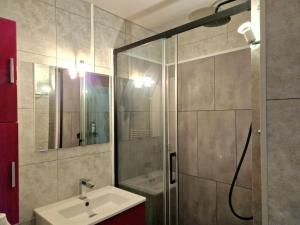 a bathroom with a shower and a sink at Joli appartement avec balcon in Cabourg