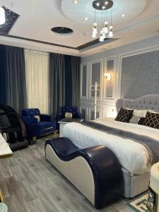 a bedroom with a large bed and blue chairs at جوهرة الاماكن in Taymāʼ +87 photos