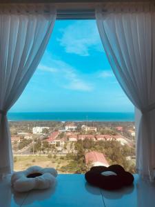 a window with a view of the ocean at Ghé Home - Homestay Phú Yên in Phu Yen