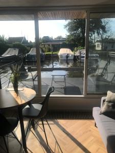 a living room with a view of a marina at Quiet Waterloft near Amsterdam and Schiphol WS11 in Aalsmeer