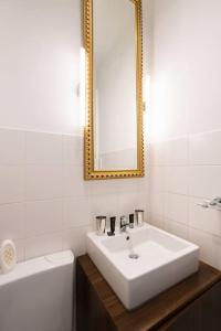 uma casa de banho com um lavatório, um espelho e uma banheira em Vienna Residence, Gumpendorfer Straße - Mariahilf #527 em Viena