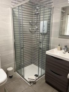 a bathroom with a shower and a sink at Chapel Place, Town Centre in Killarney