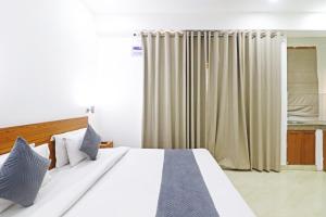 a bedroom with a large white bed and curtains at Hotel Trendy residency in New Delhi