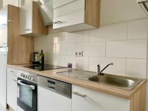 a kitchen with a sink and a stainless steel counter top at 55m2 Stylish Apartment with Netflix - 15 min to Center in Vienna