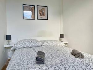 a bedroom with a bed with shoes on it at 55m2 Stylish Apartment with Netflix - 15 min to Center in Vienna