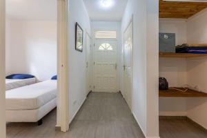 a small bedroom with a bed and a closet at Cocobana Resort two-bedroom apartment ground floor in Willemstad +15 photos