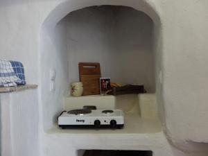 a white toaster sitting on a shelf in a wall at Kavousi Cottages - H Petra in Kavoúsion