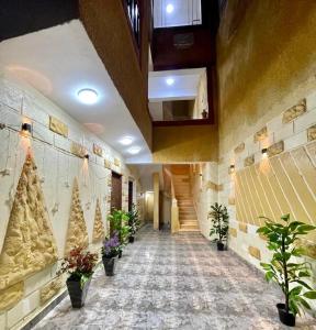 a hallway with christmas trees and plants in a building at Secret of Horus in Cairo