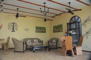 a living room with chairs and a table at El Pueblito Iguazú in Puerto Iguazú