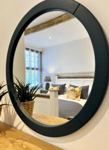 a mirror in a room with a bed at Nine Cooper Lane, Holmfirth in Holmfirth