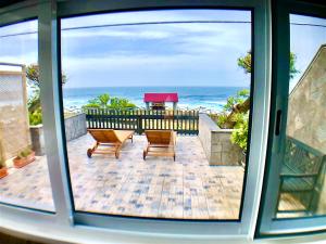 a view of a patio with a view of the ocean at Sea Roots "Sea Zone" in Mosteiros