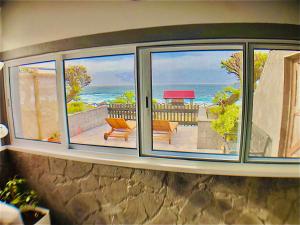a room with a window with a view of the ocean at Sea Roots "Sea Zone" in Mosteiros