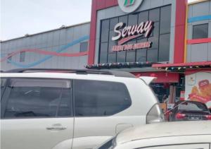 a white truck parked in front of a store at May Room Semporna in Semporna
