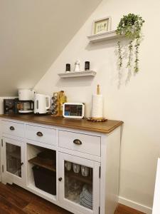 a kitchen with a white cabinet with a counter top at Ferienwohnung Samy in Bayreuth +15 photos