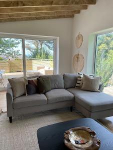 a living room with a couch and a table at The Pines, At Bull Bay in Amlwch