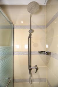 a shower with a glass door in a bathroom at Swiss Blue Alsteen in Jeddah