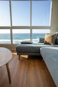 a bedroom with a bed and a large window at O&O Group - Amazing Seaview 3 BR Apartment in Bat Yam