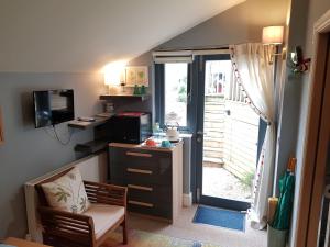 a room with a desk and a television and a door at South Ford Haven in Dartmouth
