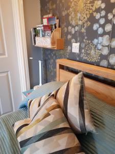 a bedroom with a bed with a wooden headboard at South Ford Haven in Dartmouth